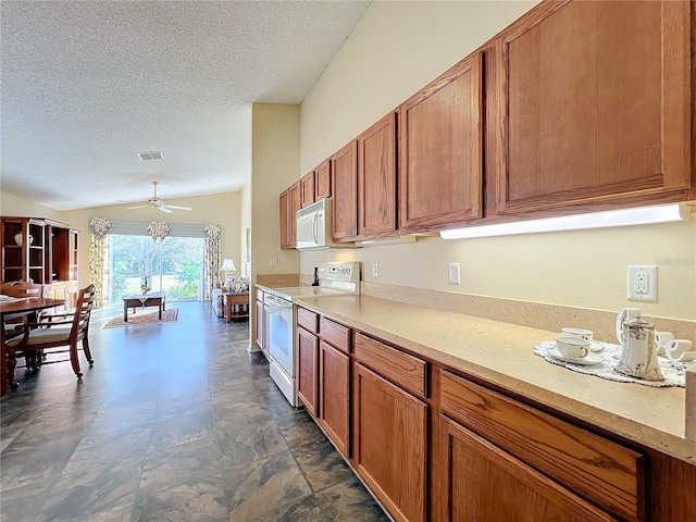 kitchen featuring a textured ceiling, white appliances, vaulted ceiling, and ceiling fan