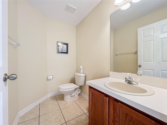 bathroom with tile patterned flooring, vanity, and toilet