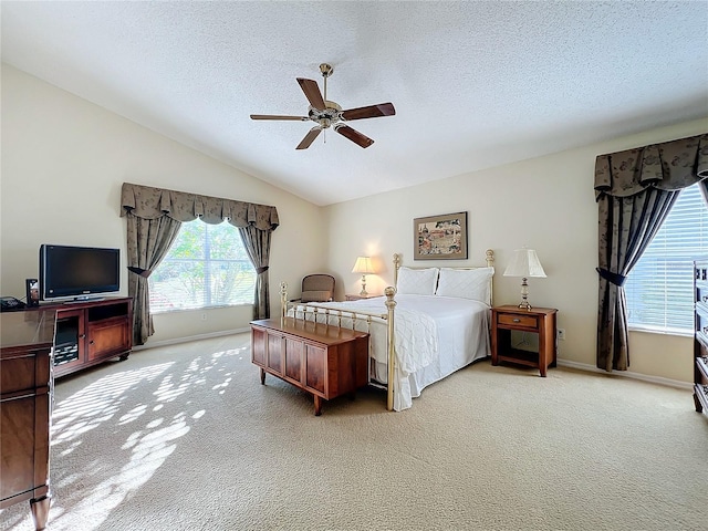 carpeted bedroom featuring a textured ceiling, ceiling fan, and lofted ceiling