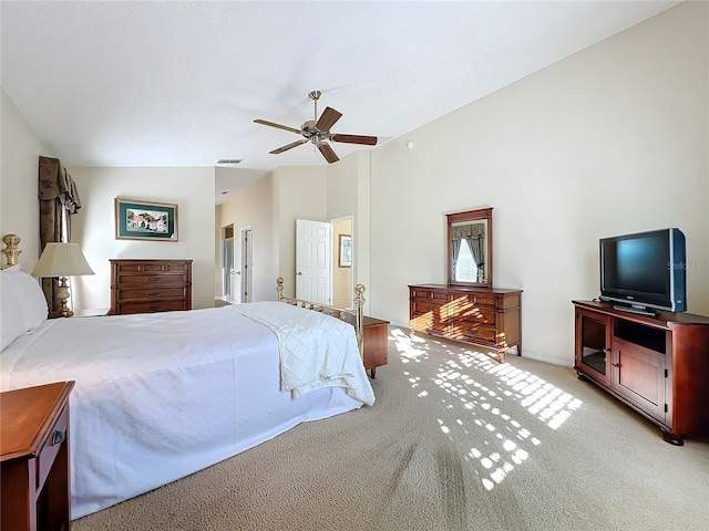 bedroom with light colored carpet, vaulted ceiling, and ceiling fan