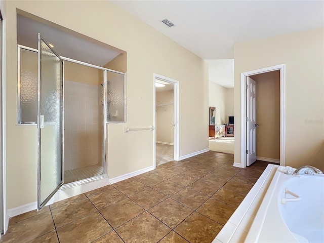 bathroom featuring tile patterned flooring and independent shower and bath