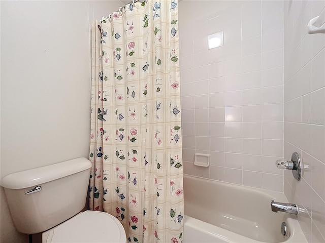 bathroom with shower / tub combo with curtain and toilet