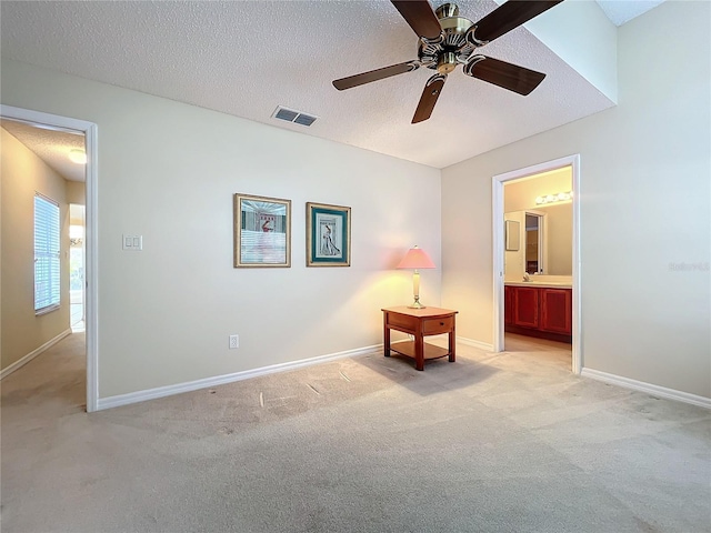 interior space featuring ceiling fan and a textured ceiling