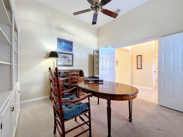 carpeted office with ceiling fan