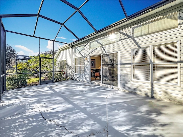 view of patio featuring glass enclosure