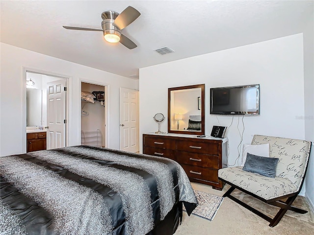 bedroom with connected bathroom, a closet, a spacious closet, and ceiling fan