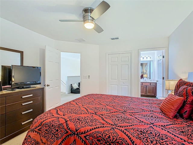 bedroom with a closet, ceiling fan, and ensuite bathroom