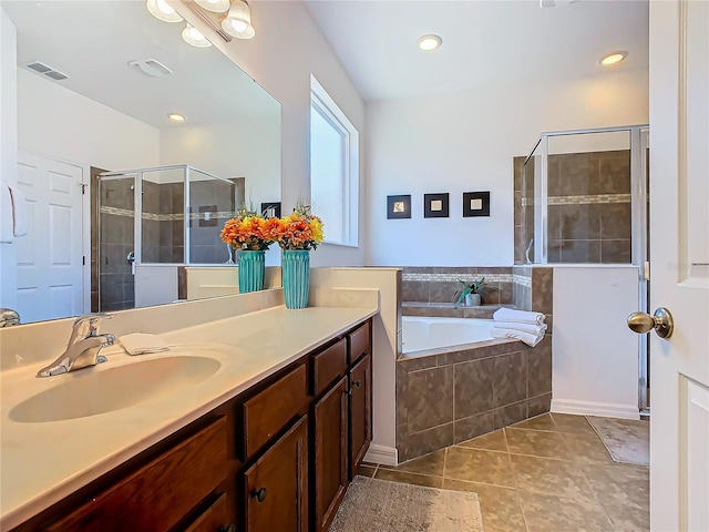 bathroom with tile patterned flooring, shower with separate bathtub, and vanity