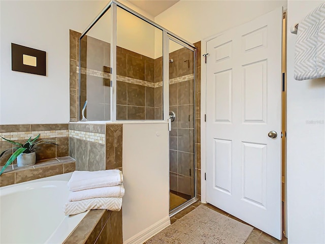 bathroom featuring tile patterned flooring and separate shower and tub