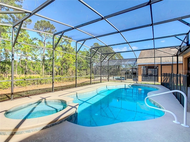 view of pool featuring glass enclosure and an in ground hot tub