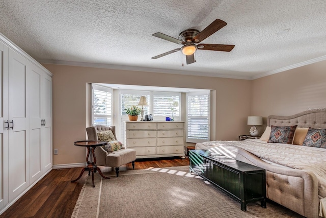 bedroom with ceiling fan, dark hardwood / wood-style flooring, ornamental molding, and a textured ceiling