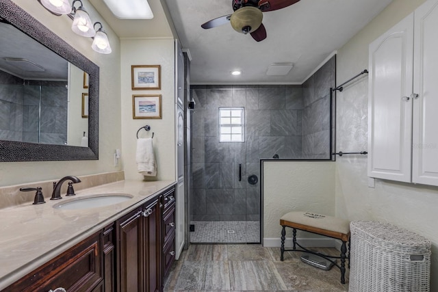 bathroom featuring ceiling fan, vanity, and a shower with shower door