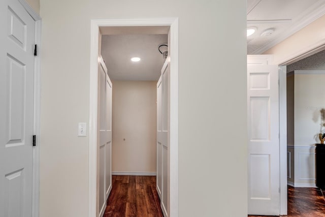 hall with dark hardwood / wood-style floors and ornamental molding