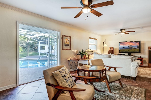 living room featuring tile patterned floors, ceiling fan, and crown molding