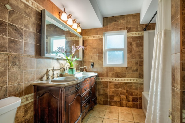 full bathroom with tile patterned floors, shower / tub combo with curtain, tile walls, and toilet