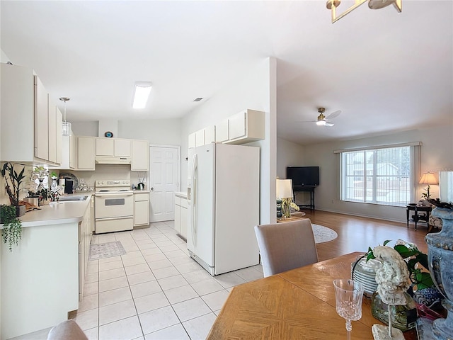 kitchen with white appliances, white cabinetry, hanging light fixtures, ceiling fan, and light tile patterned floors