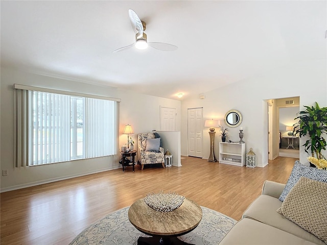 living room with light wood-type flooring and ceiling fan