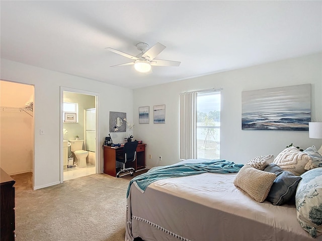 carpeted bedroom with a spacious closet, ceiling fan, a closet, and connected bathroom