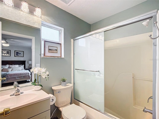 full bathroom featuring toilet, vanity, ceiling fan, and shower / bath combination with glass door