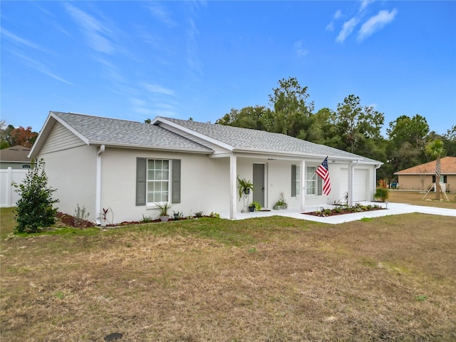 single story home featuring a front lawn and a garage