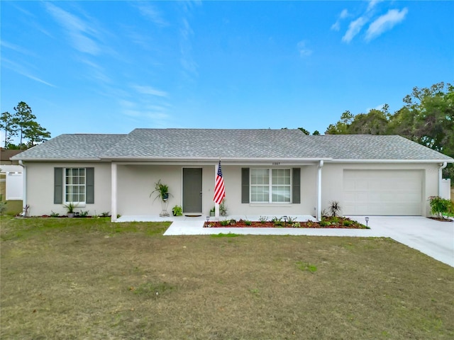 single story home featuring a front yard and a garage