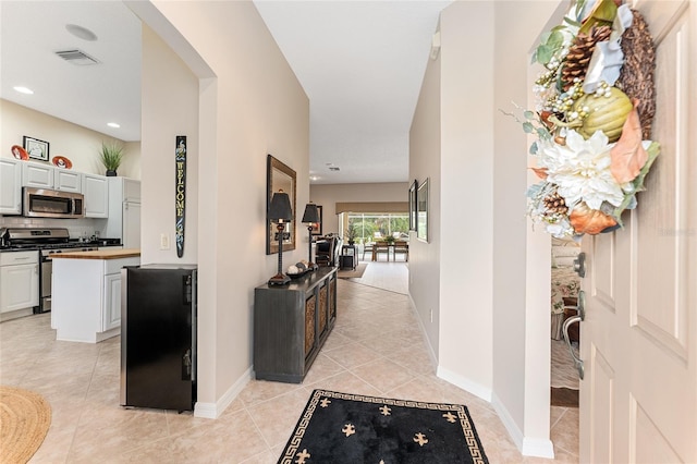 hallway with light tile patterned floors