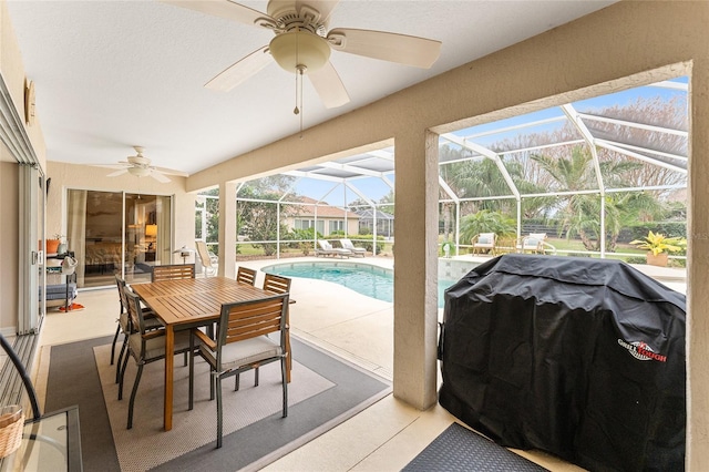 view of patio / terrace with ceiling fan, a grill, and glass enclosure