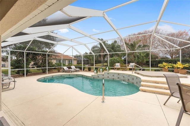 view of swimming pool with a lanai, pool water feature, and a patio area