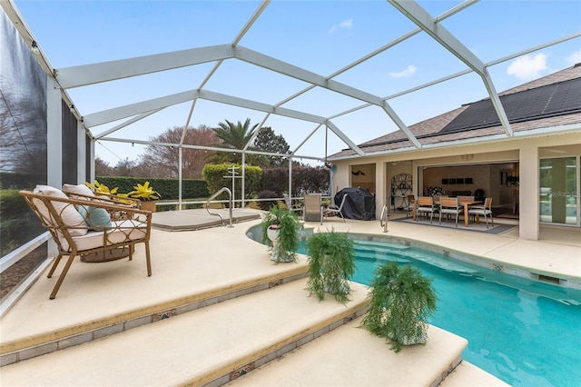 view of pool featuring glass enclosure, a patio area, and a grill