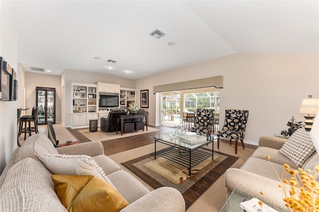 living room featuring vaulted ceiling