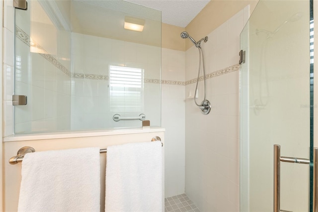 bathroom featuring a textured ceiling and walk in shower