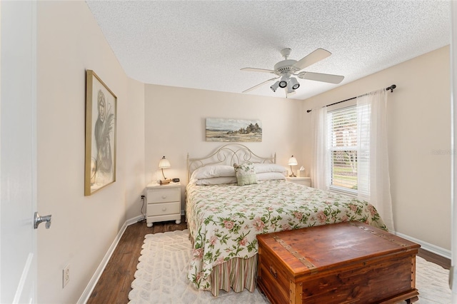 bedroom featuring ceiling fan, wood-type flooring, and a textured ceiling