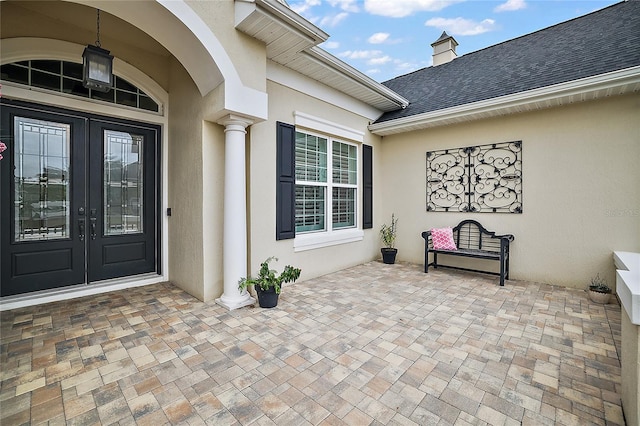 view of exterior entry featuring french doors