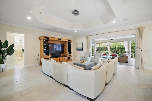 living room featuring a tray ceiling and ornamental molding