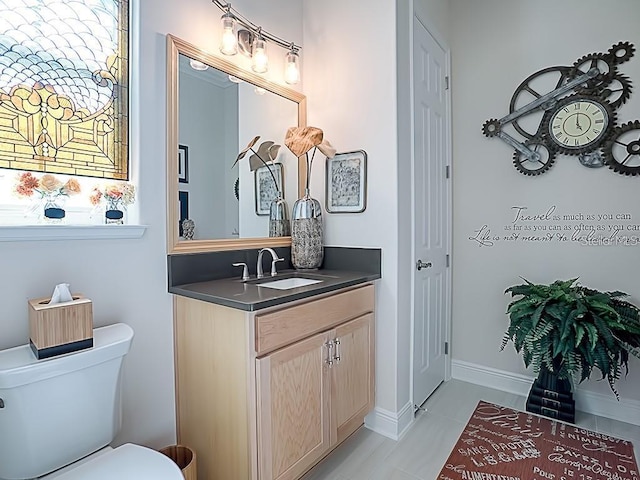 bathroom with tile patterned floors, vanity, and toilet