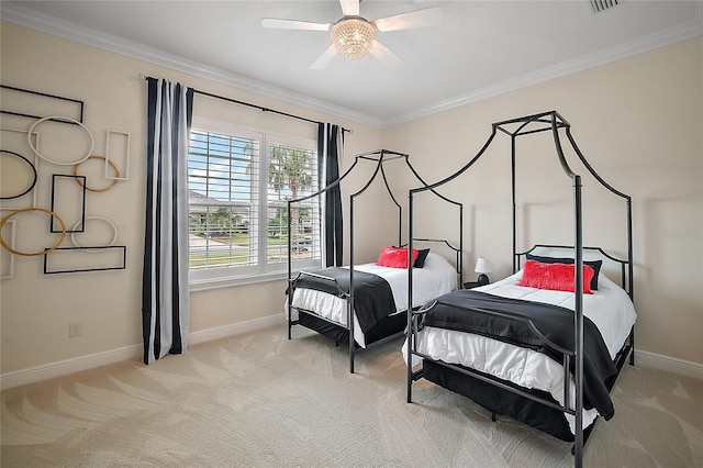 carpeted bedroom with ceiling fan and ornamental molding