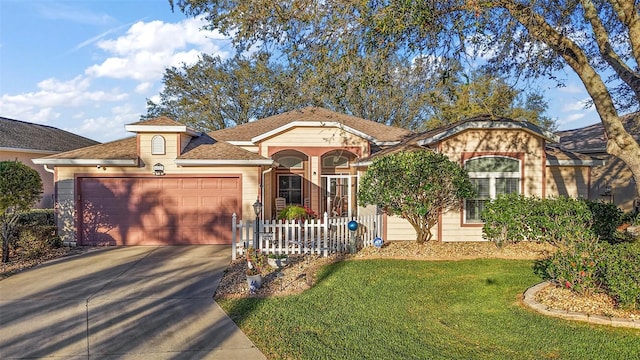 view of front of house with a shingled roof, a front yard, driveway, and an attached garage