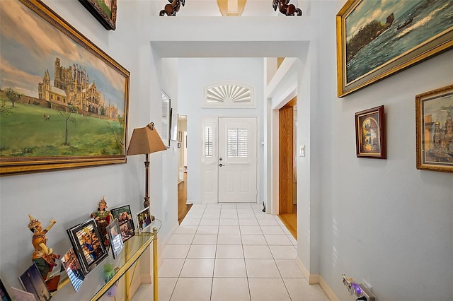 entrance foyer featuring light tile patterned flooring and baseboards