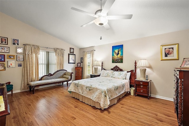 bedroom featuring light wood-style floors, lofted ceiling, ceiling fan, and baseboards