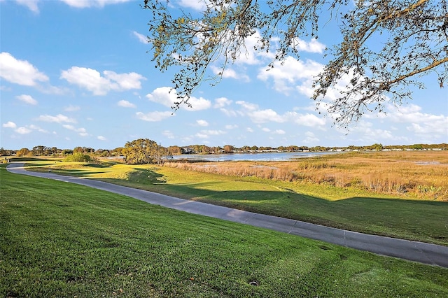 surrounding community featuring a water view and a yard