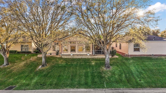 single story home with a front lawn and stucco siding