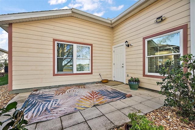 view of exterior entry featuring a patio area