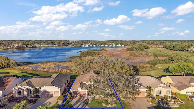 birds eye view of property with a water view and a residential view