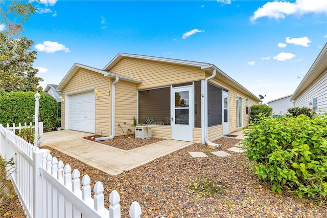 view of front of property with a sunroom and a garage