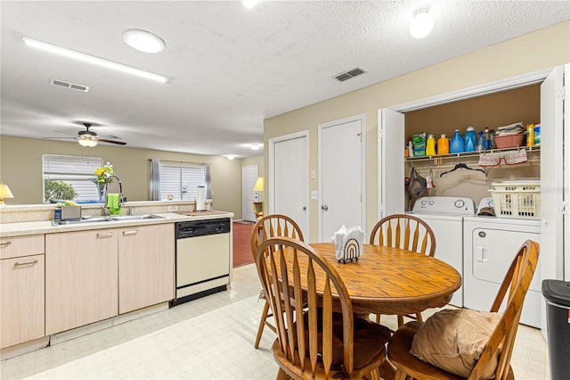 interior space with sink, a textured ceiling, dishwasher, ceiling fan, and washing machine and dryer