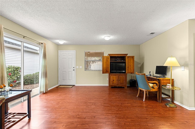 office area with a textured ceiling and wood-type flooring