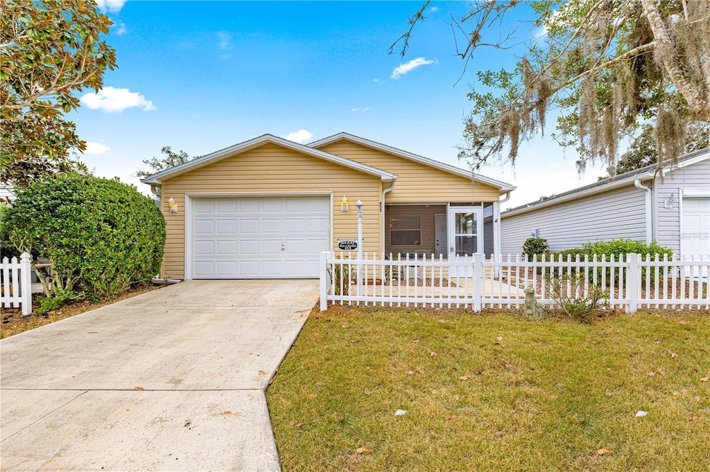 ranch-style home featuring a garage and a front lawn