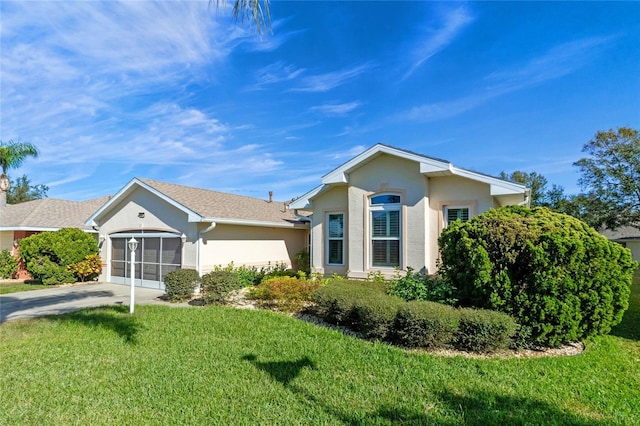 ranch-style house with a garage and a front lawn