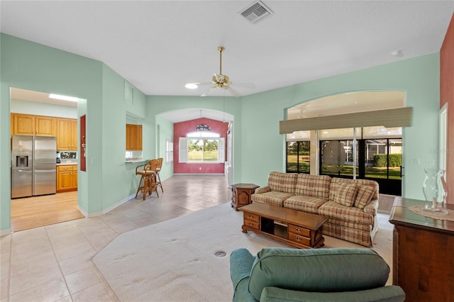 living room with ceiling fan and light tile patterned flooring