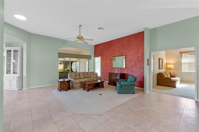 living room with ceiling fan and light tile patterned flooring